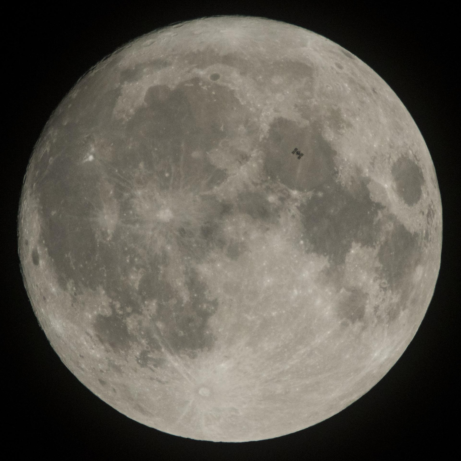 The International Space Station as a small silhouette against the face of the Moon, photographed from Pennsylvania on 2 December 2017.